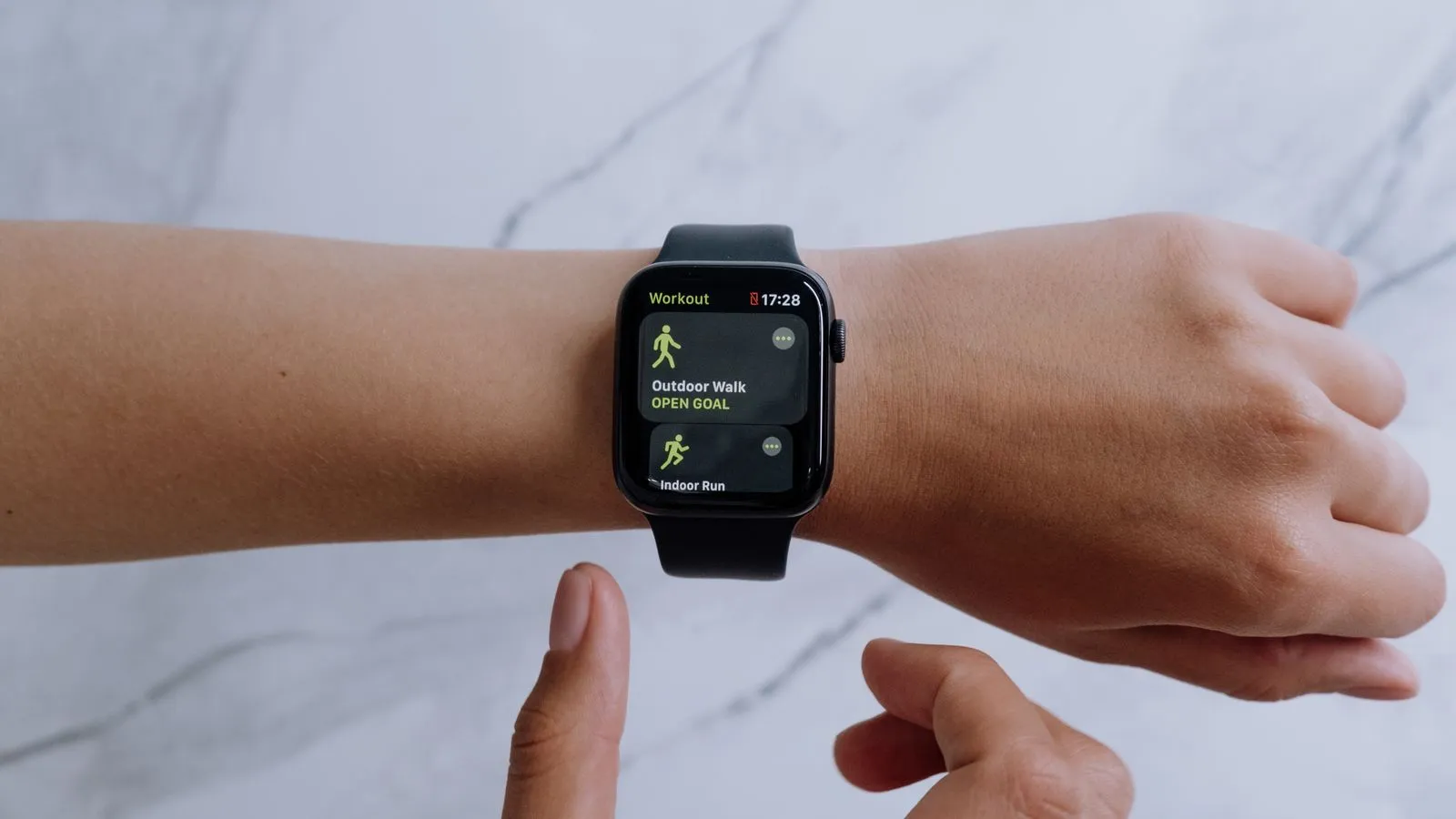 A fitness tracker showing heart rate on the wrist
